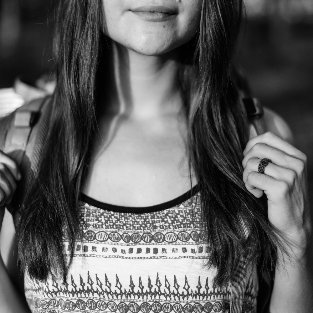 Black and white image of girl with backpack and long hair