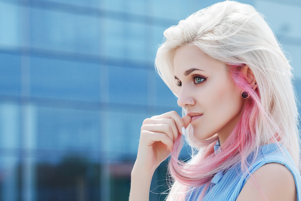woman with blonde and pink hair thinking