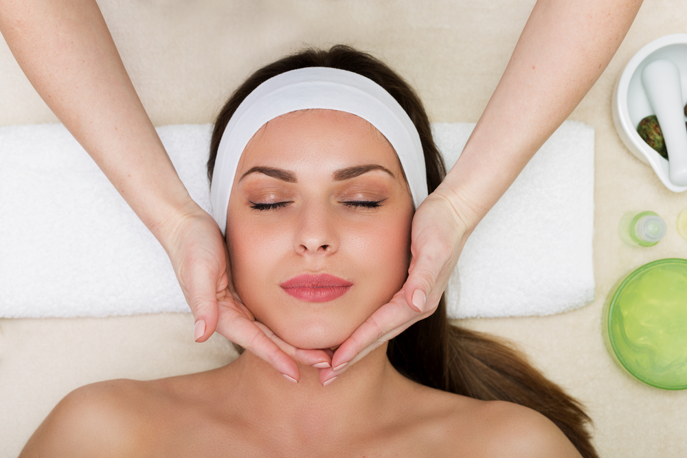 Woman getting a facial wearing a white headbanc