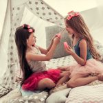 two little girls doing hair