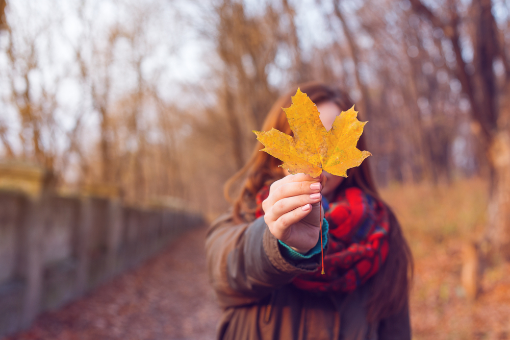 Woman holding leaf