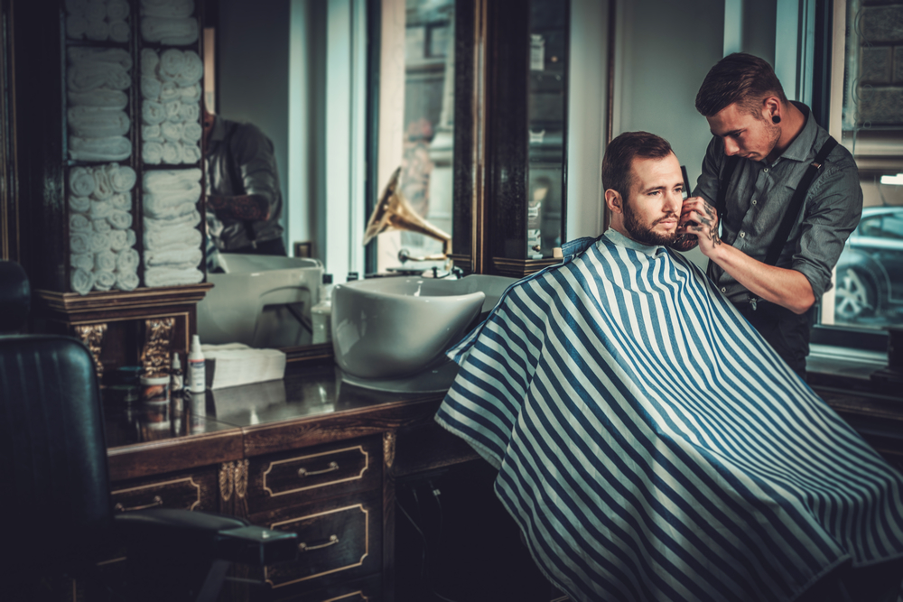 barber giving customer a shave