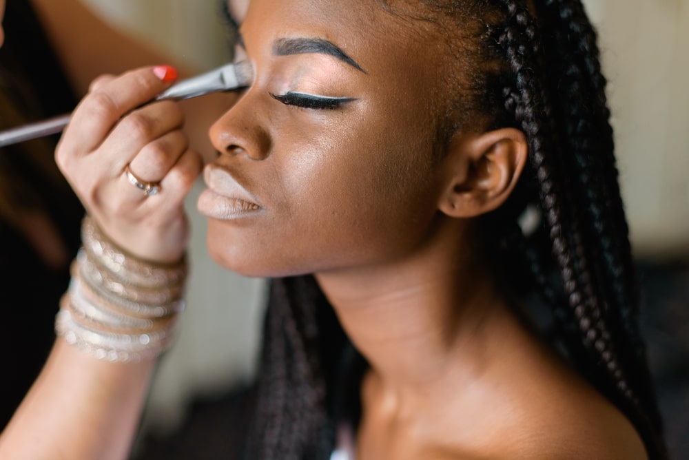 woman getting her eye makeup done