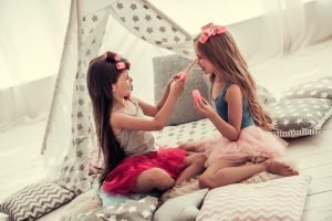 two little girls doing hair